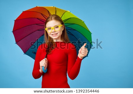 woman in glasses holding a beautiful rain umbrella                               