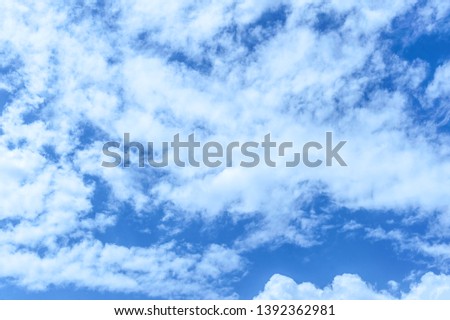 light fluffy clouds on a bright blue sky 