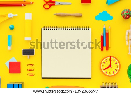 Blank notepad and set of school supplies.