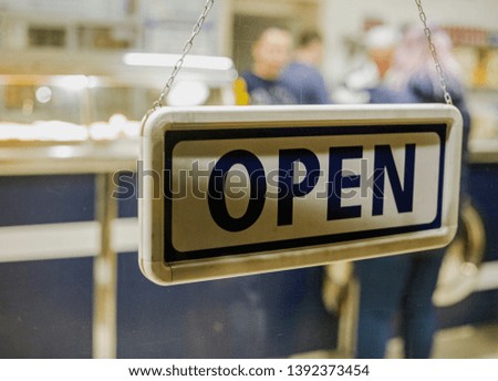 Shop sign at a chip shop reading "open"