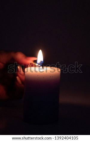 Picture facing a light candle