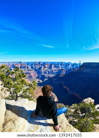 man enjoy the views on nevada, california and utah, grand canyon and horse shoe, great western of usa.