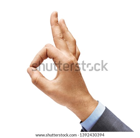 Man's hand in a suit shows gesture okay. Positive concept. Close up. High resolution product
