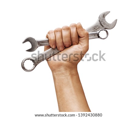 Man's hand holds a spanners isolated on white background. Close up. High resolution product Royalty-Free Stock Photo #1392430880