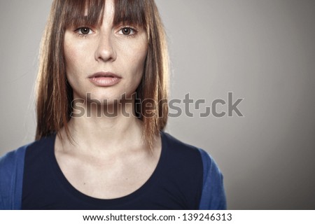 Beautiful young woman in studio looking at camera/ Close up of a normal girl
