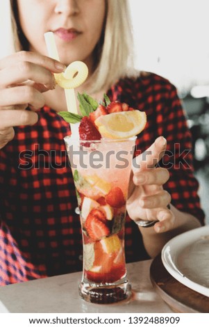delicious colored cocktail in the hand at girl