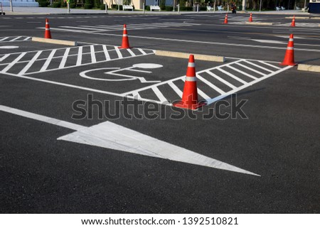 Handicap symbol on road parking areas reserved for disabled people.