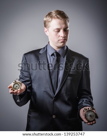 young man holding two alarms