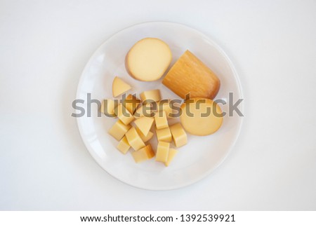 Provolone cheese plate on a white background Royalty-Free Stock Photo #1392539921