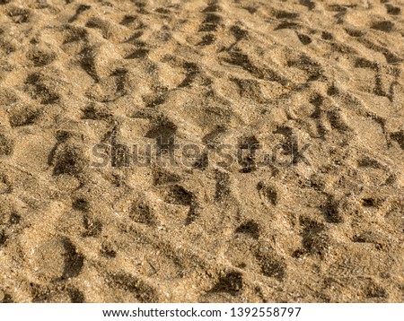 Beach sand with footprints as a background