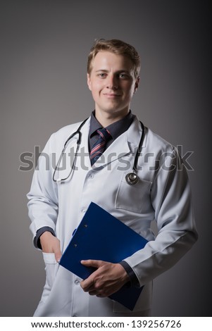 Happy doctor with clipboard