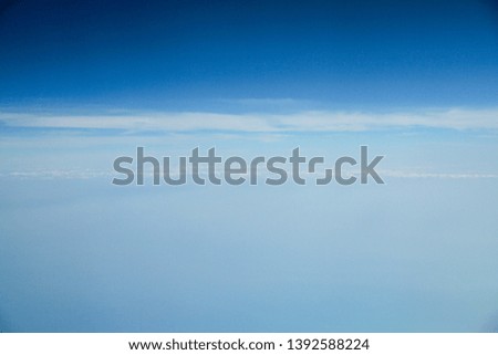 blurry picture of horizon in blue sky and white clouds