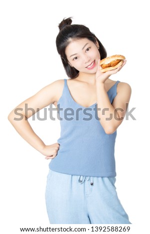 Beautiful Chinese American woman eating a Chicken Sandwich isolated on a white background