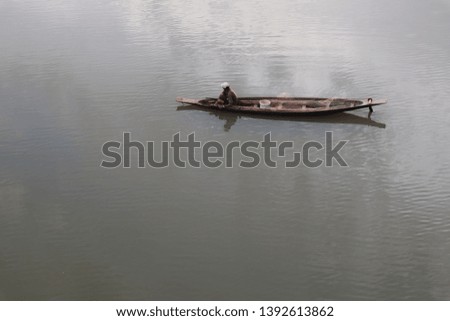 sitFishermen  on a boat in the river.
