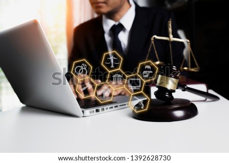 Male notary working with laptop on table in lawyer's office, justice and law concept.