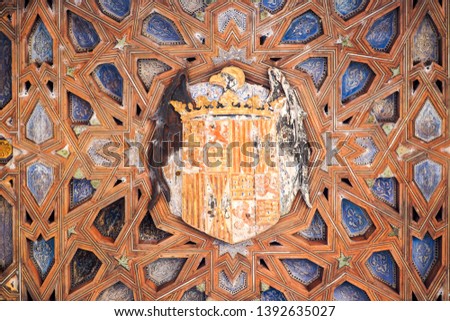 A beautiful ancient wood carving decoration on the ceiling inside ancient palace Alcázar of Seville.
