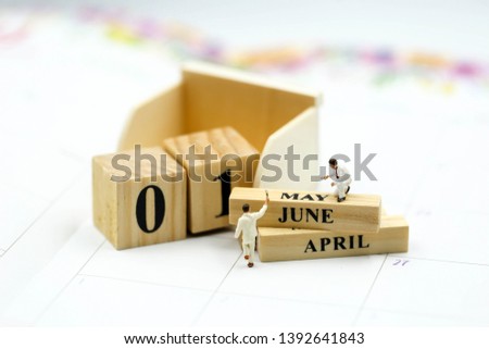 Miniature people : Wooden block calendar date and mounth with miniworld.