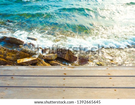 brown wood on the seaside and soft ocean wave to rocks with Summer,Holiday,Vacation and Travel concept