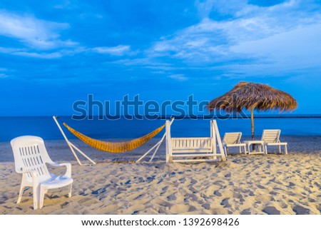 Summer vacations concept, Happy with relaxing in hammock on the beach at Cha Am, Thailand.