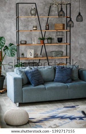 Modern living room interior with blue sofa lamp and green plants on grey wall background,minimal designs. Royalty-Free Stock Photo #1392717155