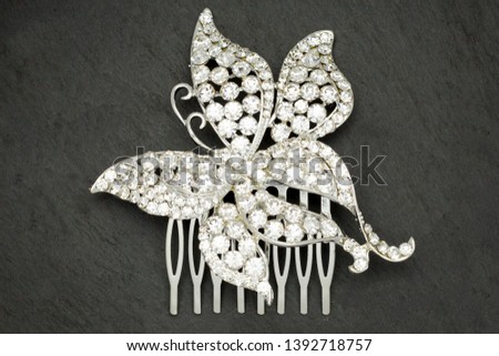 silver  bridal hair comb with diamonds isolated  on stone background, stock photography