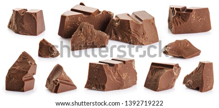 Pieces of milk chocolate isolated on white background. With clipping path. Royalty-Free Stock Photo #1392719222