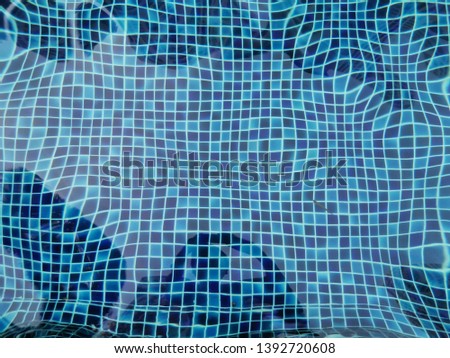 Top view of swimming pool bottom caustics ripple and flow with waves background. Summer background. Texture of water surface. abstract backdrop.