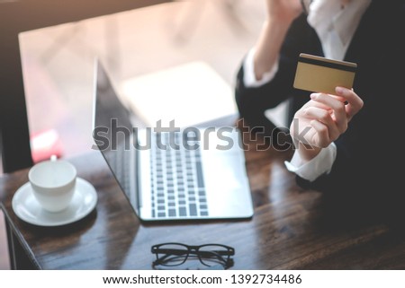 Discuss credit card business on the office desk with laptops and digital tablets.