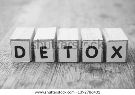 Closeup of word on wooden cube on wooden desk background concept - Detox
