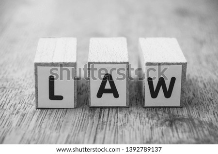 Closeup of word on wooden cube on wooden desk background concept - Law