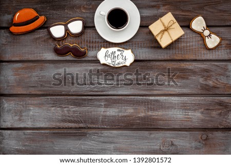 Happy Father Day with hat, glasses, moustache cookies, gift and coffee on wooden background top view mockup