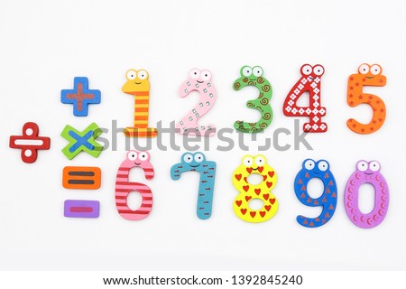 colorful funny bright school numbers and symblols plus minus and other on the white background 