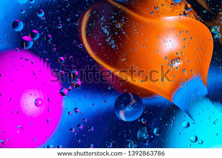 Mixing water and oil on a beautiful color abstract background gradient balls circles and ovals