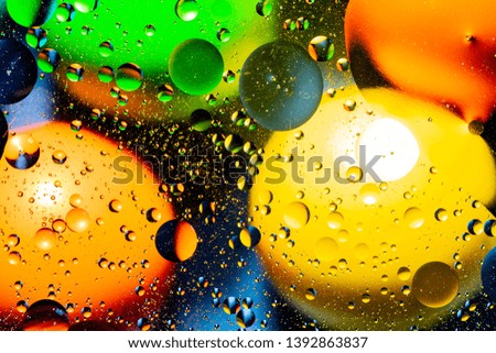Mixing water and oil on a beautiful color abstract background gradient balls circles and ovals