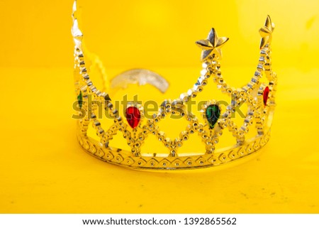 Silver crown, close-up photo. Women's head jewelry. Yellow background.