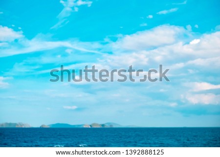 blurred beautiful expanse of turquoise tropical sea and white puffy clouds complete picture of tropical paradise in Kohsamui Thailand.
