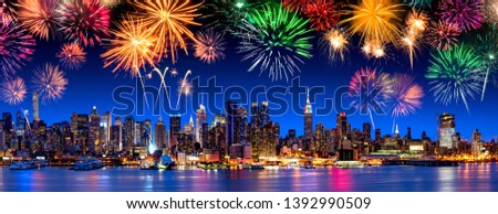 Manhattan skyline panorama at night with fireworks, New York City, USA