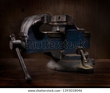 old press (walrus) on wooden table and dark background of similar material