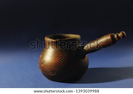 Clay coffee pot on classic blue color of the year 2020 background