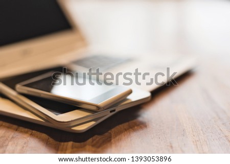 phone and tablet on a laptop, closeup image