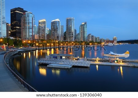 Coal Harbor Morning, Vancouver. Condominiums at twilight reflecting in the calm water of Coal Harbor in downtown Vancouver. British Columbia, Canada.