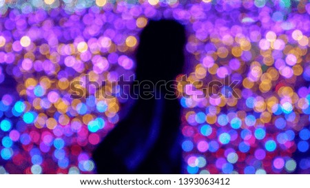 Abstract blur bokeh background with the silhouette of woman 