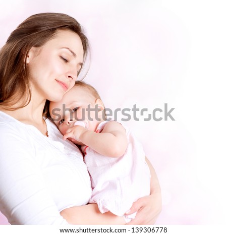 Mother and Baby kissing and hugging. Happy Family Royalty-Free Stock Photo #139306778