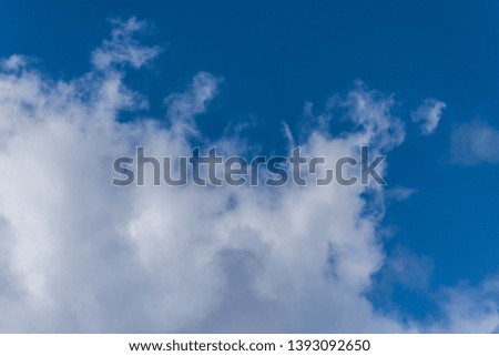 Fluffy soft huge cloud on the blue sky