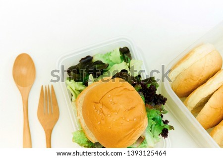 Salad and bread with wooden spoon, fork on gray background. Selective focus