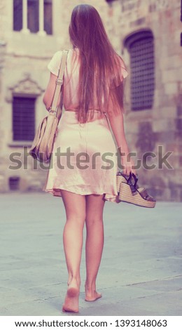 Young smiling woman walking in historic city center