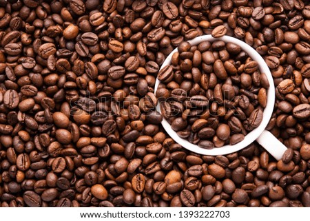 white cup of coffee beans top view