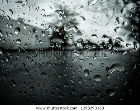 Drops of rain on the glass in the dark scenery