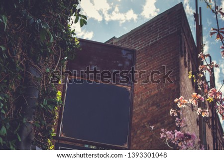 A view of a blank store front sign in a rustic urban lifestyle environment.