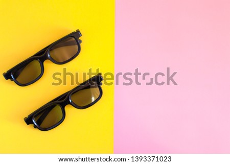 Flat lay design. View above of two pair 3D glasses on red-blue background with copy space